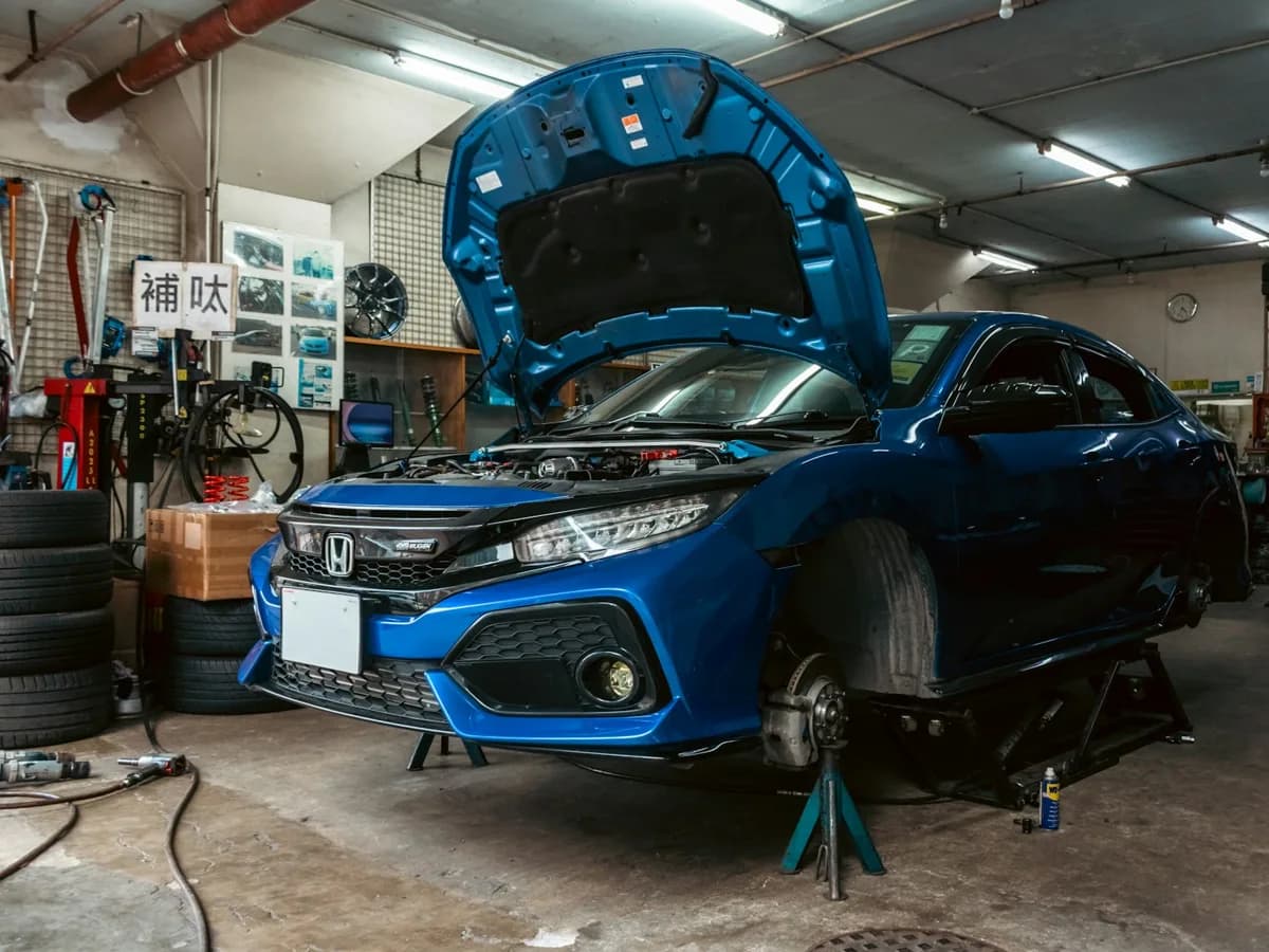A car raised on a lift in a modern repair shop