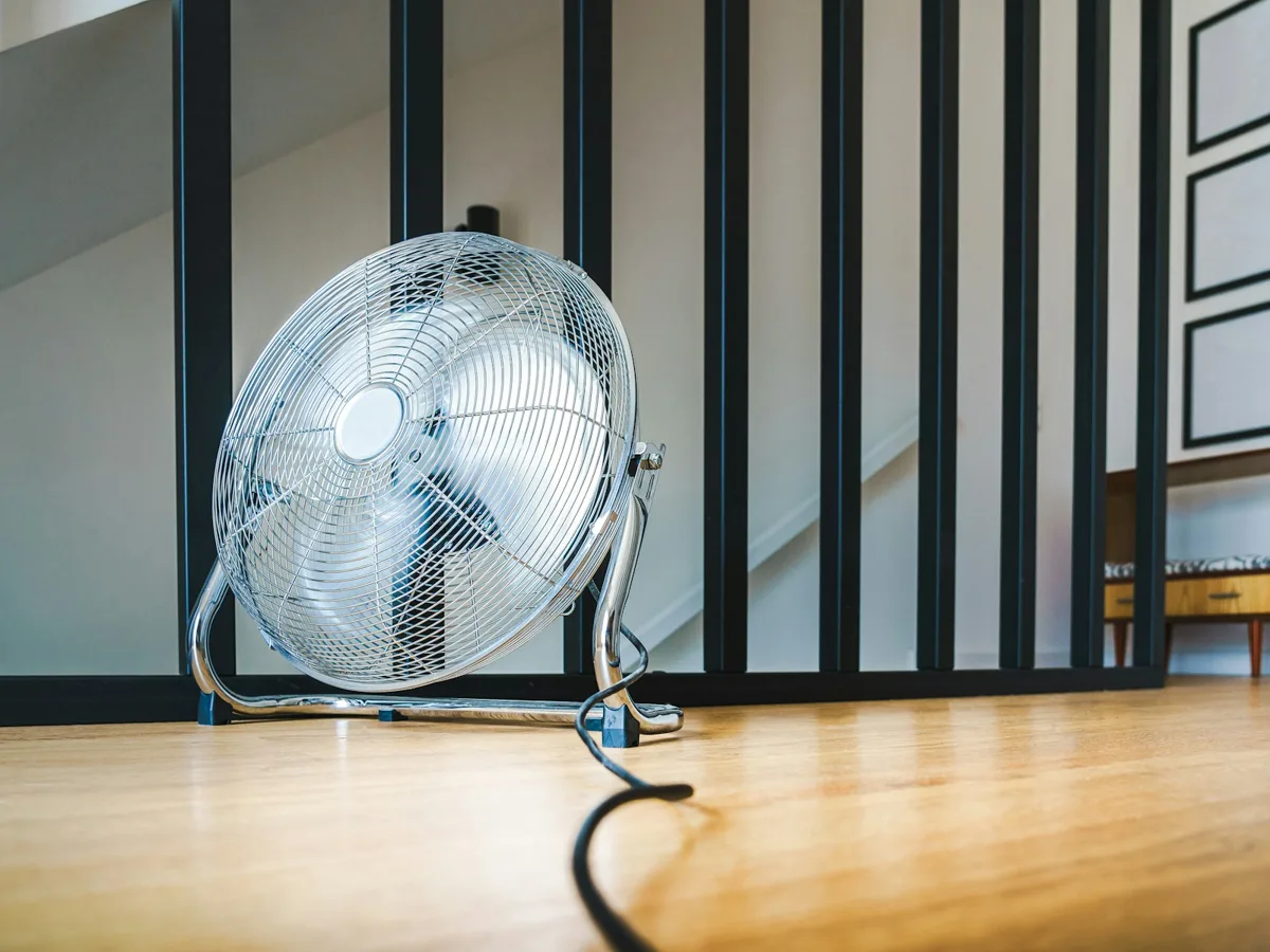 An air mover drying a water-damaged interior